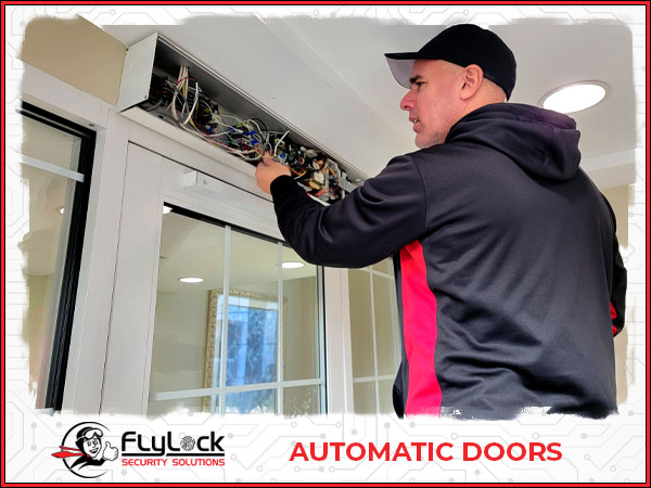 Image of an Access Control Specialist Troubleshooting an Automatic Door Operator